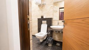 a bathroom with a toilet and a sink at Holiday In Homestay in Shimla +38 photos
