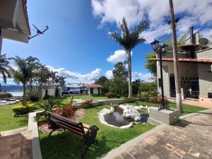 a park with a bench in front of a building at Cabaña MACA in Darién