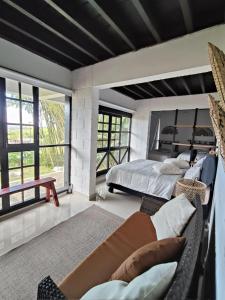 a bedroom with a bed and a couch at Cabaña MACA in Darién