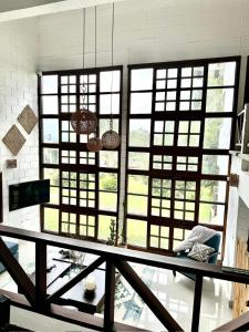 a large room with large windows and a table at Cabaña MACA in Darién +29 photos