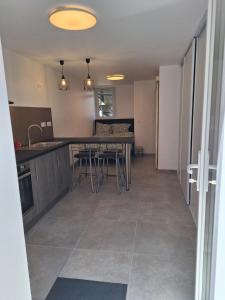 a kitchen and dining room with a table and chairs at La Campanule in Saint-Cyr-en-Pail +6 photos