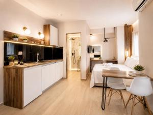 a kitchen and living room with a bed and a table at ATHONITE all seasons luxury suites in Ierissos