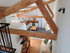 an overhead view of a kitchen and living room with wooden beams at Chez Audrey in Courthézon