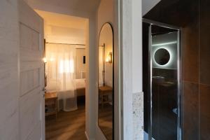 a bathroom with a mirror and a bedroom with a bed at Chioggia Rooms in Chioggia