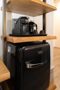 a toaster oven with a coffee maker on top of it at Chioggia Rooms in Chioggia