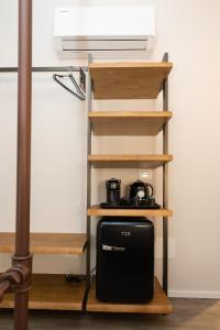 a black suitcase sitting on a shelf in a room at Chioggia Rooms in Chioggia +48 photos