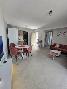 a living room with a table and chairs and a couch at 9muses luxury rooms in Vasiliki