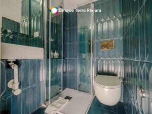 a green tiled bathroom with a toilet and a shower at Picagetta Tiny Room with AC in Vernazza +23 photos