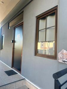 a room with two windows and a door at Letsios Steel1 in Kalabaka