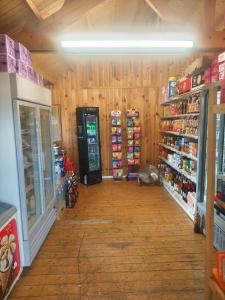 a store aisle with a soda machine in a store at Les mobil homes d’oliver rob in Saint-Chéron