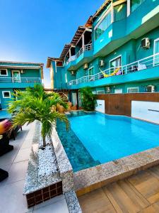 a swimming pool in front of a building at Pousada Mirante da Prainha in Arraial do Cabo