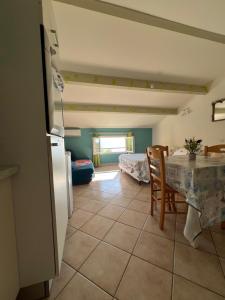 a kitchen and dining room with a table and chairs at vue mer Studio 2/3 pers 1 bed + 1 cot in Farinole