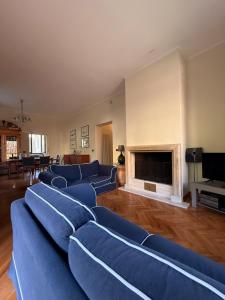 a living room with blue couches and a fireplace at Relax on the Sea in Pizzo