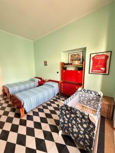 a room with two beds and a checkered floor at Relax on the Sea in Pizzo