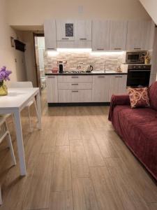a kitchen and living room with a couch and a table at Mimmo Wanderlust in Mazzeo