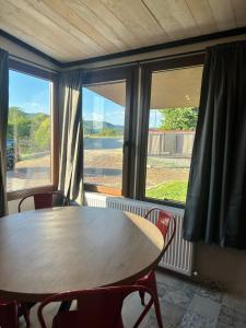 a table and chairs in a room with a window at Letsios Steel3 in Kalabaka +7 photos