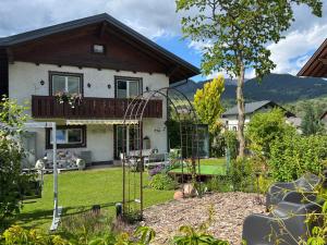 a house with a balcony in a garden at Ferienhaus Gruber in Aich