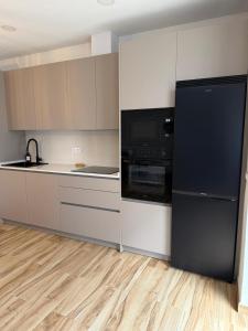 a kitchen with a black refrigerator and a counter at Casa Pedro in Almodóvar del Río +39 photos