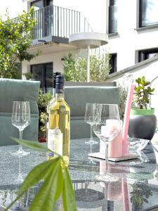 a bottle of wine sitting on a table with glasses at Gartenstudio Anila in Cochem