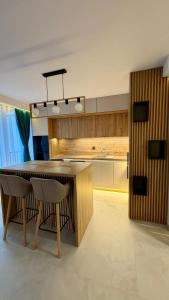 a kitchen with a wooden table and some chairs at River View Penthouse & Jacuzzi in Reghin