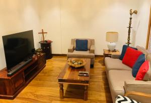 a living room with a couch and a tv at Gedara Boutique in Katunayaka