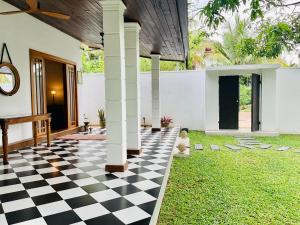 a black and white checkered floor in a house at Gedara Boutique in Katunayaka