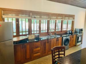 a kitchen with a sink and a refrigerator at Gedara Boutique in Katunayaka