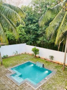 a small swimming pool in the middle of a yard at Gedara Boutique in Katunayaka