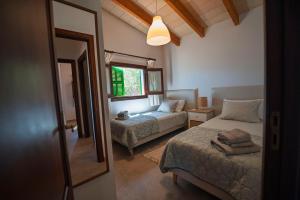 a bedroom with two beds and a mirror at Maricel in Cala Ratjada +58 photos