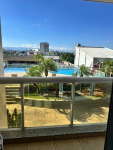 a balcony with a view of a pool at Flat Mercure Nova Iguaçu in Nova Iguaçu