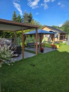 a backyard with a gazebo and a playground at Domek Komfort z jakuzzi przy Parku Zdrojowym in Rabka-Zdrój