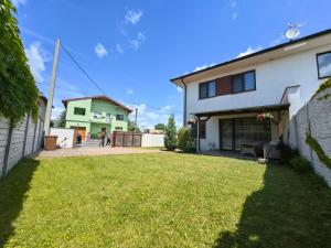 a house with a lawn in front of it at Apartment J&D in Dunajská Streda