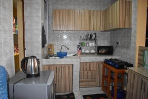 a kitchen with a sink and a refrigerator at Unique Place 1 Bedroom Thika in Thika