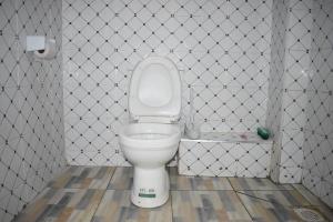 a white toilet in a bathroom with a tile wall at Unique Place 1 Bedroom Thika in Thika +13 photos