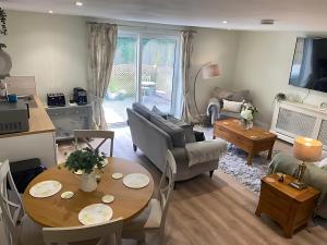 a living room with a couch and a table at Breach Lodge in Bonvilston