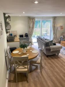 a living room with a table and a couch at Breach Lodge in Bonvilston