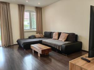 a living room with a couch and a coffee table at Apartment J&D in Dunajská Streda