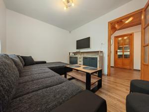 a living room with a couch and a table at Napsugár Vendégház Velence in Velence