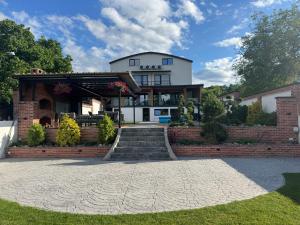 a large house with a brick wall and stairs at Casa DAVIANA in Luna de Sus