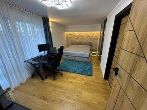 a bedroom with a bed and a desk with a computer at Casa DAVIANA in Luna de Sus +16 photos
