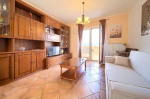 a living room with a couch and a table at Apartman Pina in Vrbnik +12 photos