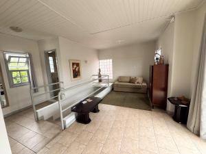 a living room with a staircase and a couch at Morada Pé de Laranja in Lages
