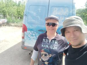 two young men standing in front of a van at Алима in Ottuk