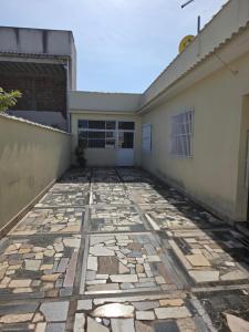a patio outside of a building at Suíte independente com cozinha e varanda in Piúma