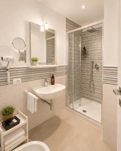 a bathroom with a sink and a shower and a toilet at Hotel Luxor Florence in Florence +38 photos