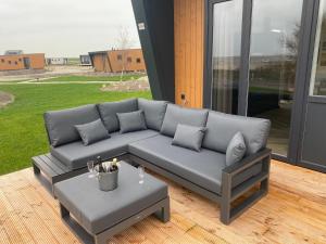a living room with a couch and a table at Maristella 332 in Hindeloopen
