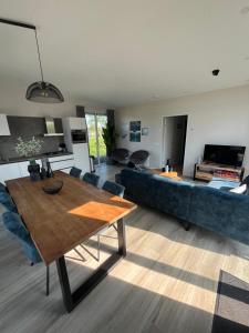 a living room with a blue couch and a table at Maristella 332 in Hindeloopen