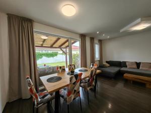 a living room with a table and chairs and a couch at Apartment J&D in Dunajská Streda