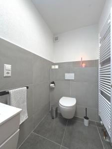 a bathroom with a toilet and a sink at Gartenstudio Anila in Cochem +72 photos