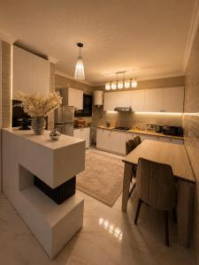 a large kitchen with a table and a dining room at Stunning view in Madinaty in Madinaty